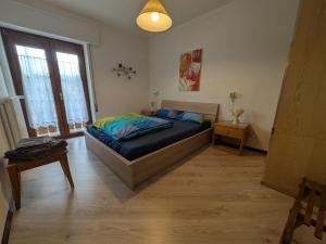 a bedroom with a bed in a room with a window at Casa Stocke - Relax e natura in Contrà Zocchi in Asiago
