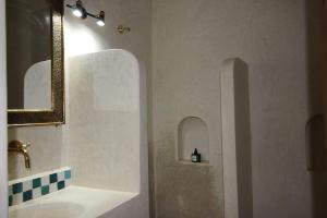 ein Badezimmer mit Waschbecken und Spiegel in der Unterkunft Palais el Abbassia in Marrakesch + 22 Fotos