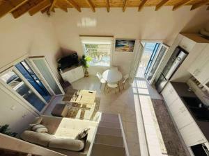 a large living room with a couch and a table at Aegean View Apartment in Skala Eresou