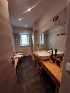 a large bathroom with two sinks and a mirror at Appartamento a Tesero in Tesero