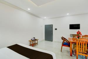a bedroom with a bed and a dining room with a table at Collection O Karmanghat Bus Terminal Hyderabad Formerly Hotel Chirag Stays in Hyderabad