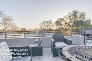 a patio with a table and chairs on a balcony at Self Checkin-Luxury Tranquil Unit in Johannesburg