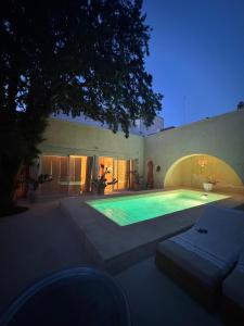 a swimming pool in the backyard of a house at Palazzo Giustiniani L'Ambasciatore in Sogliano Cavour