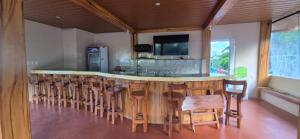 a bar in a room with a bunch of chairs at Cliffhouse Kalinga in Tinglayan