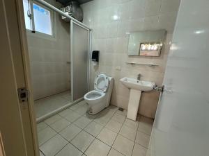 a bathroom with a toilet and a sink at 輕鬆玩民宿 in Luodong +11 photos