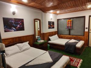 a bedroom with two beds and a chalkboard in it at The Jasmit Mount View Homestay in Kalimpong +13 photos