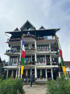 a building with a person standing in front of it at The Jasmit Mount View Homestay in Kalimpong