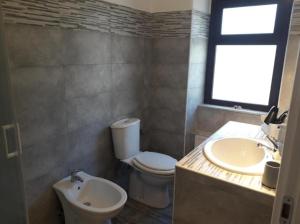 a bathroom with a toilet and a sink and a window at Fontanarossa Airport Sleep and Travel 1 in CTA +15 photos