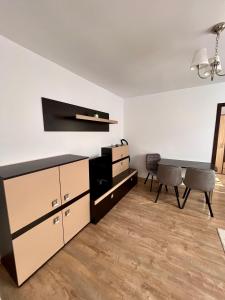 a living room with a desk and a table at Focus Apartment in Miercurea-Ciuc +15 photos