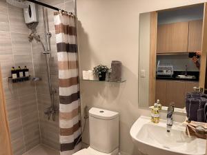 a bathroom with a shower and a toilet and a sink at Solinea Residences 30thfloor Tower4 Ayala Business Center Cebu ph in Cebu City +34 photos