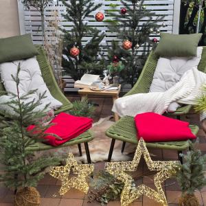 a patio with christmas trees and chairs and christmas decorations at City APART - FeWo Klimaanlage Whirpool Panoramafenster 5 Personen Kulturdenkmal Dessau-Roßlau in Dessau