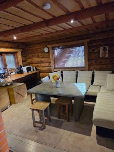 a living room with a table and a couch at Saunamaja, Taalbergi Kodumajutus OÜ in Nogo