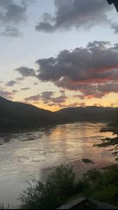 a view of a river at sunset with clouds at Mekong Backpackers 2 PB in Pakbeng