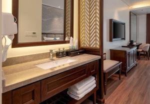 a bathroom with a sink and a large mirror at De La Mont Hotel Ha Giang in Ha Giang +27 photos