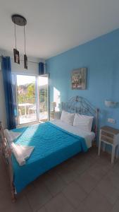 Ένα ή περισσότερα κρεβάτια σε δωμάτιο στο Aelia Studios