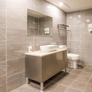 a bathroom with a sink and a toilet at 와이케이호텔 in Suwon