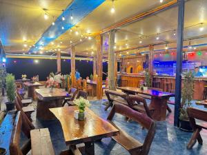 a restaurant with wooden tables and chairs and a bar at Lanta Island Resort in Ko Lanta