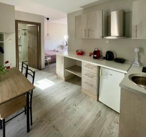 a kitchen with a counter and a dining room at Panoramic suite in Kastoria