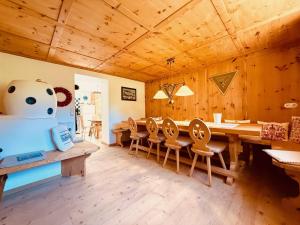 a dining room with a large wooden table and chairs at Haus Freistabl in Sölden