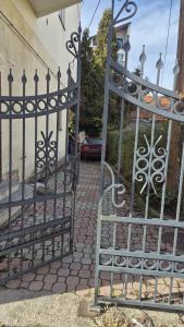 an iron gate in front of a house at Big & Bright City Center Apartment in Užice