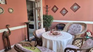 a dining room with a table and chairs with a bowl on it at Big & Bright City Center Apartment in Užice