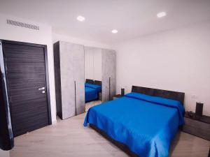 a bedroom with a blue bed and a closet at Alisea Home in Nerano +31 photos