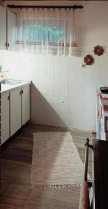 a kitchen with a rug on the floor and a window at Konak Pahulja TARA in Bajina Bašta +26 photos