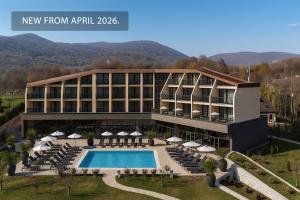 a hotel with a swimming pool in front of a building at Hotel Degenija in Seliste Dreznicko
