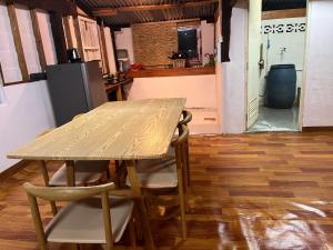 a table and chairs in a kitchen with a refrigerator at Balance home happy in Ban Laem Sai