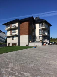 a large apartment building with a parking lot in front of it at Willa Dwie Mewy in Władysławowo