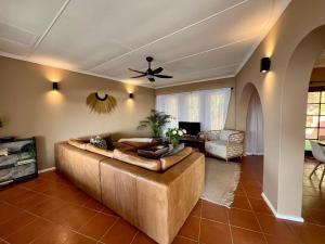 a living room with a large couch and a table at Casa Bellé Bluff in Durban