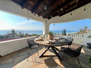 a table on a patio with a view of the ocean at Casa Bellé Bluff in Durban