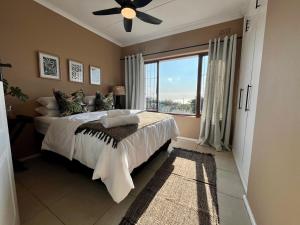 a bedroom with a bed and a large window at Casa Bellé Bluff in Durban +10 photos