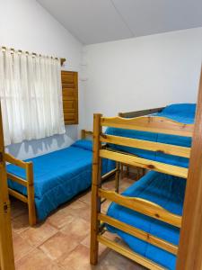 a room with two bunk beds and a window at Casas Rurales La Navela in Blanca