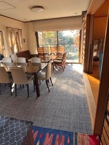 a dining room with a table and chairs at 離れの宿 かぶろの庭 in Matsukawa