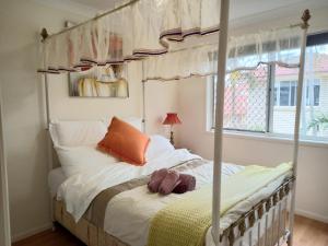 a bedroom with a canopy bed and a window at Youth Castle in Brisbane