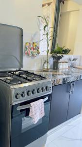 a kitchen with a stove with a towel on the oven at Myra Luxury Homes in Kololo- Your Family Oasis in Kampala
