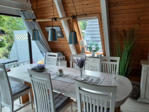 a dining room with a white table and chairs at Zum-Piraten in Damp +21 photos