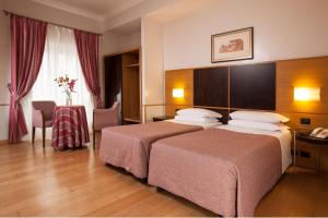Posteľ alebo postele v izbe v ubytovaní Hotel Piemonte