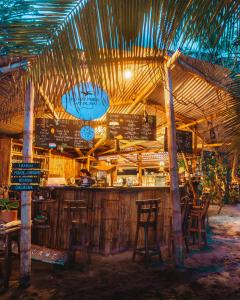 a bar in a restaurant with chairs and a bar counter at Lote 10 Tayrona Glamping in Guachaca +72 photos