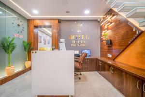 an office with a desk and a sign on the wall at Hotel Deol's Paradise in Indore