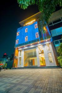 a building with blue lights on the front of it at Hotel Deol's Paradise in Indore