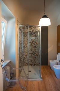 a bathroom with a shower and a toilet at Cottage di design con giardino in Bosco Marengo +29 photos