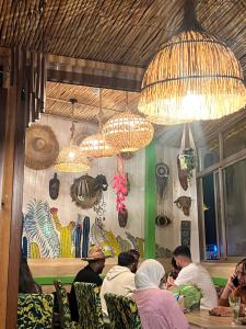 a group of people sitting at a table in a restaurant at Art riad mazighen in El Jadida +81 photos