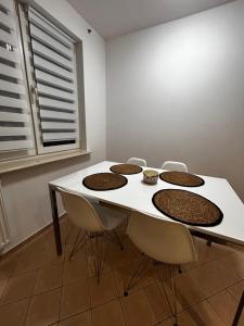 a white table and chairs in a room with a window at Apartament na wyłączność - Tarnowskie Góry - Strzybnica in Tarnowskie Góry +7 photos