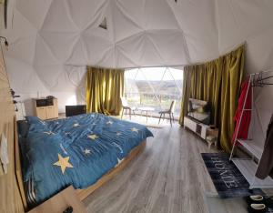 a bedroom with a bed in a tent at GlampingDenis Igloo in Mihăeşti +19 photos