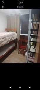 a bedroom with a bed and a ladder and a chair at Casa container in São Lourenço do Sul