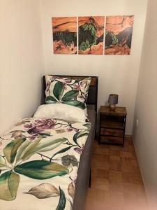 a small bedroom with a bed and a night stand at Ferien - Monteurwohnung Roding in Roding