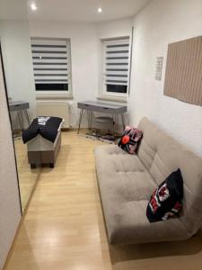 a living room with a couch and a table at Ferien - Monteurwohnung Roding in Roding