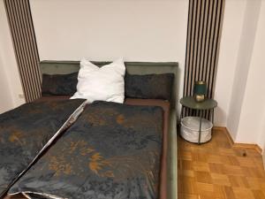 a bedroom with a bed with a pillow and a table at Ferien - Monteurwohnung Roding in Roding